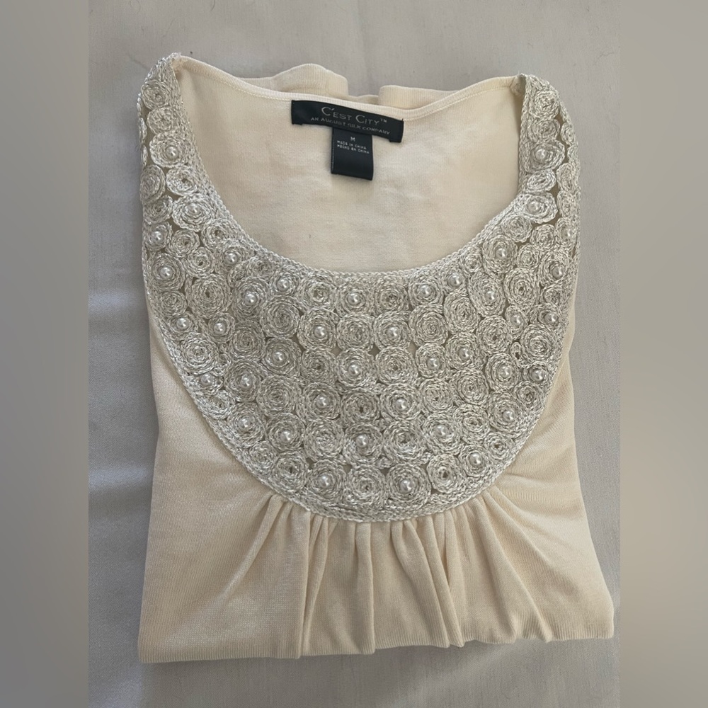 C’est coty women’s top.  Ivory with embellishment around collar. EUC size M